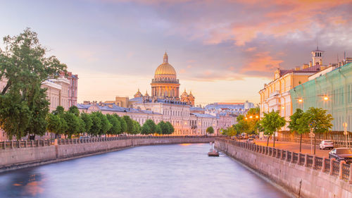 View of buildings in city against sky during sunset