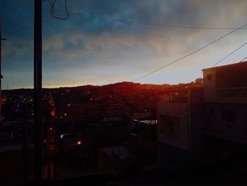 Buildings in city against sky at dusk