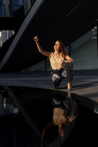 Beautiful woman with short hair in futuristic dubai landscape.water and landscape design. city