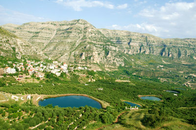 Scenic view of lake and mountains against sky