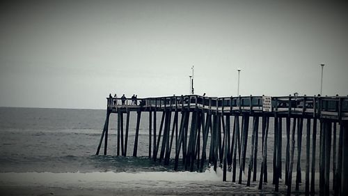 Pier on sea against clear sky