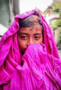 Child with pink blanket