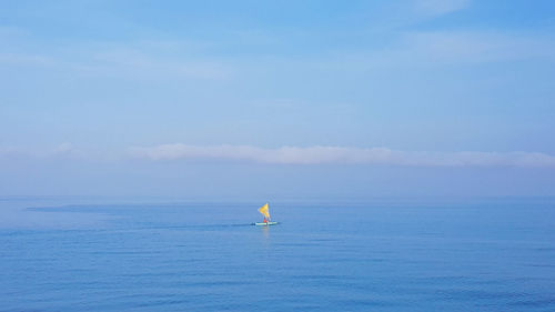 Sailboat in sea against sky