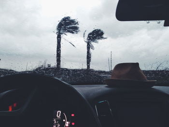 Car seen through wet glass window