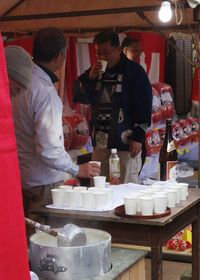 People working at market stall