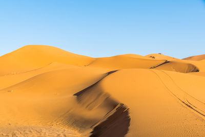 Scenic view of desert against clear sky