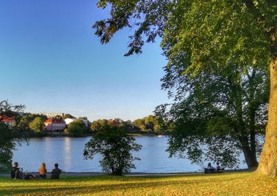 Scenic view of calm lake against clear blue sky