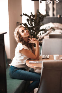 Portrait of young woman sitting at cafe