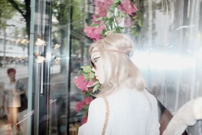 Rear view of woman looking at flowering plants