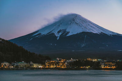 Scenic view of snowcapped mountains against sky at night