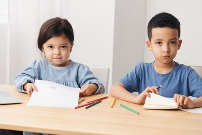 Portrait of boy studying at office