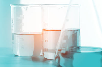 Close-up of chemicals in laboratory glassware on table