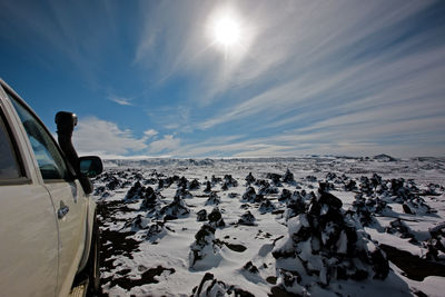 Suv driving through snowy landscape in the icelandic highlands
