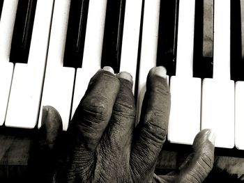 Close-up of hands playing piano