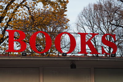 Low angle view of road sign against sky