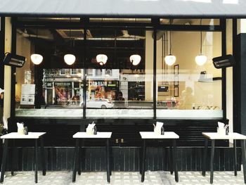 Empty chairs and tables in restaurant