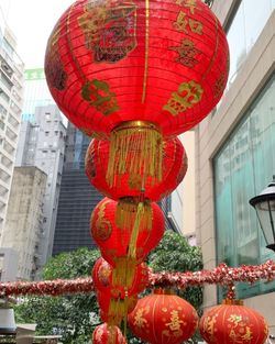 Low angle view of lanterns hanging by building