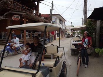 People sitting on street in city