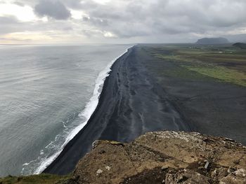 Scenic view of sea against cloudy sky