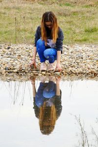 Reflection of girl in lake