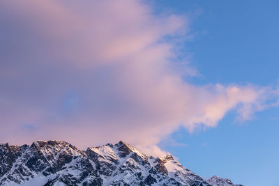 The sun sets on iconic mount currie still covered in snow on a spring day in the coast mountains of british columbia.