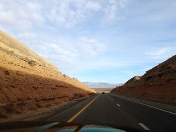 Road against sky seen through car windshield