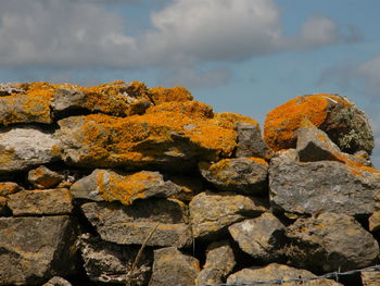 Close-up of stone wall against sky