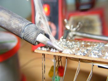 Close-up of circuit board being soldered