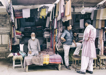 Full length of people sitting in market