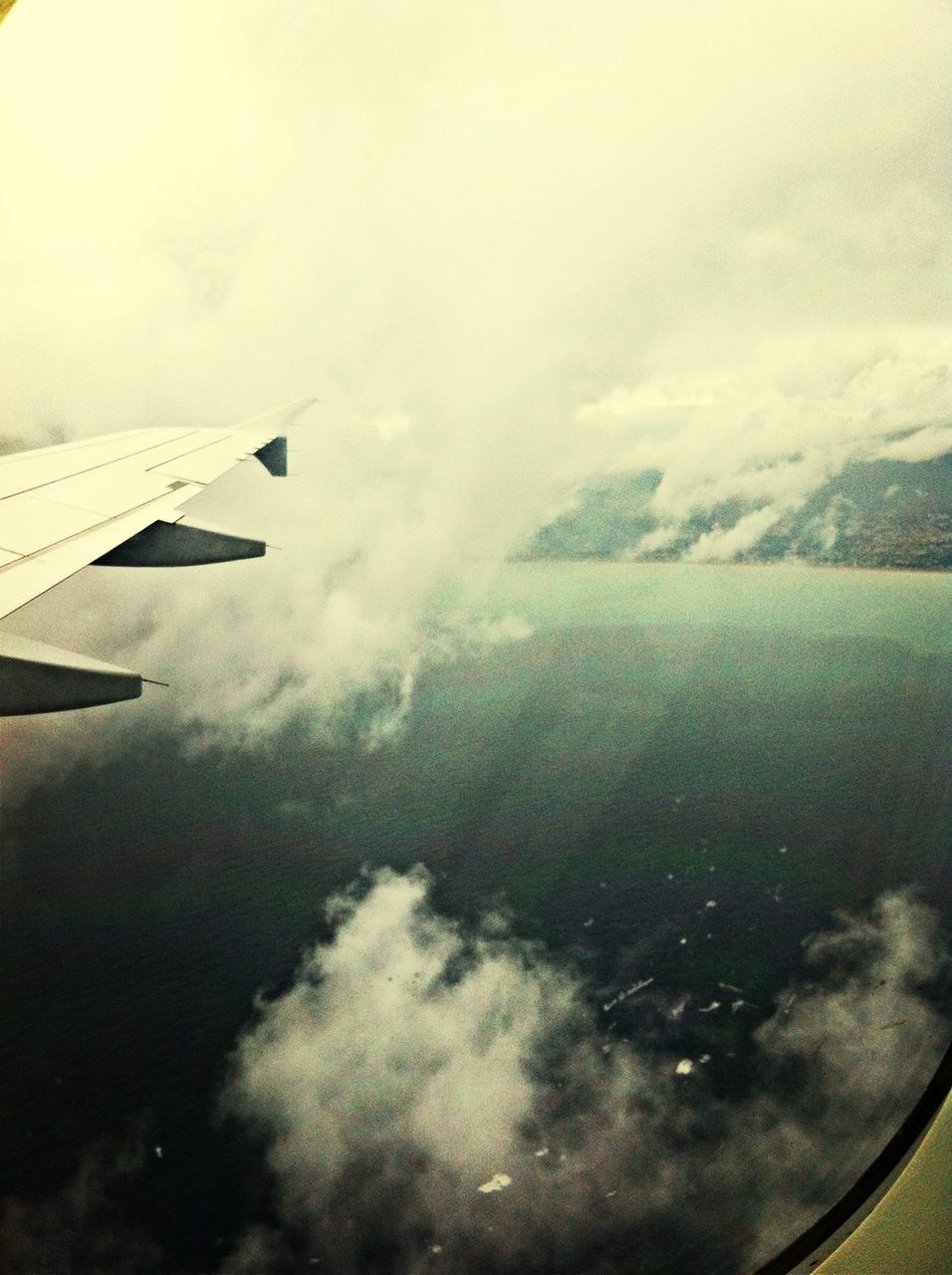 airplane, air vehicle, transportation, aircraft wing, mode of transport, flying, aerial view, part of, cropped, sky, mid-air, journey, travel, cloud - sky, scenics, airplane wing, on the move, aeroplane, nature, vehicle interior