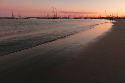 Scenic view of beach against sky during sunset