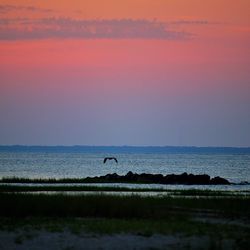 Scenic view of sea against sky at sunset