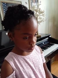 Close-up portrait of girl looking at home