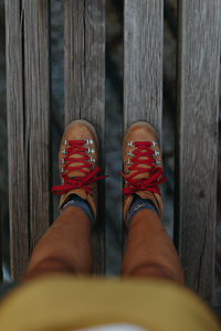 Low section of woman standing on wooden floor