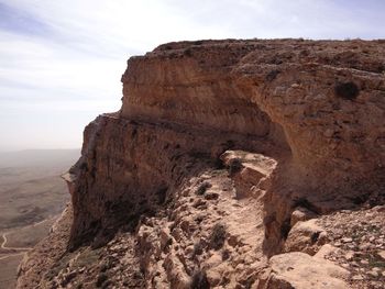 Rock formations on landscape against sky