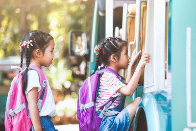 Side view of schoolgirls boarding miniature train