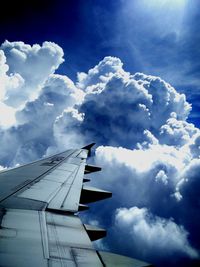 Low angle view of airplane flying against sky