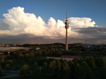 Communications tower against cloudy sky