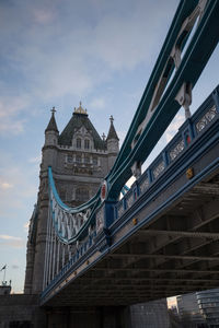 Low angle view of bridge and buildings against sky