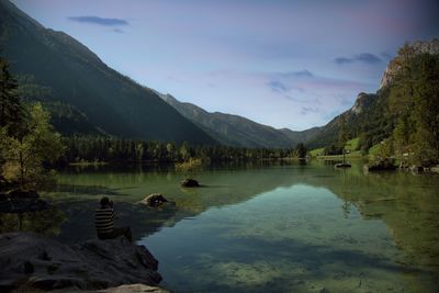 Scenic view of lake and mountains against sky