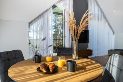 The stylish spacious luxury interior design of living room with coffee table and croissant breakfast