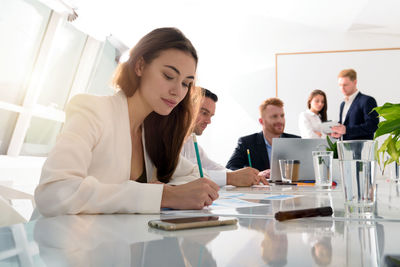Portrait of smiling business colleagues working in office