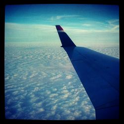 Cropped image of airplane against sky