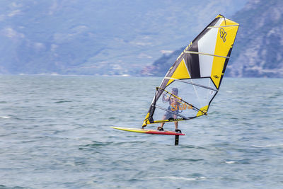 Low angle view of man in sea against sky