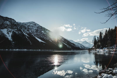 Scenic view of lake and mountains against sky