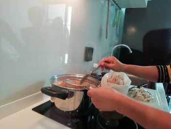 Midsection of man preparing food at home
