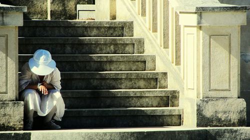 Full length of woman standing by railing