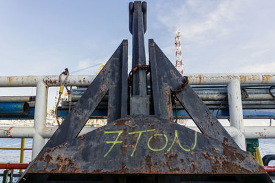 Close-up of rusty metal against sky