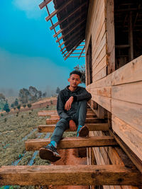 Portrait of young man sitting on steps