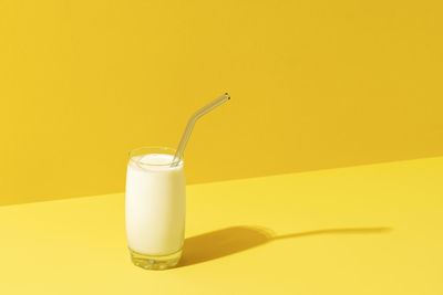 Glass of tea against yellow background